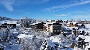 a town covered in snow with houses at Hotel Bergruh in Füssen