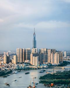 an aerial view of a city with a river and buildings at The Majesty Landmark 81 Residence in Ho Chi Minh City