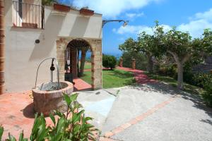 a building with a fountain in the middle of a driveway at Villa Eleanto in Cefalù