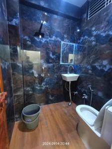 a bathroom with a toilet and a sink and a tub at Hotel Maa Dham Palace in Ayodhya