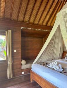 Postel nebo postele na pokoji v ubytování Island Garden Huts Lembongan