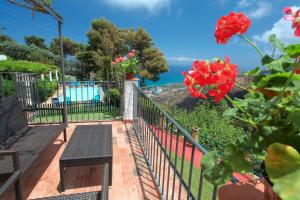 a balcony with a bench and a view of the ocean at Villa Eleanto in Cefalù