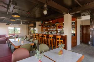 a restaurant with tables and chairs and a bar at Hollywood Hotel Puerto Princesa in Puerto Princesa City