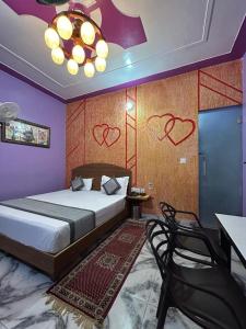 Un dormitorio con una cama y una mesa y sillas. en mshotel Loharu, en Lohāru