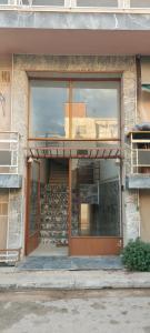 a window of a building with a reflection in it at Anna's centrum apt in Artemida