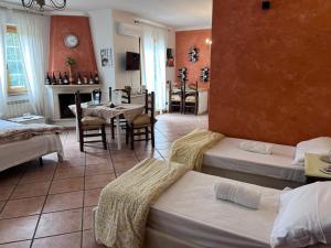 a living room with two beds and a dining room at Incanto Chic B&B nelle Scuderie in Sacrofano +92 photos