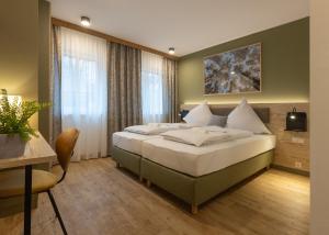 a bedroom with a large bed in a room at StadlTraum Falkenberg in Moosach