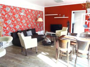 a living room with a couch and a table at Ferienhaus Loissin in Loissin +6 photos