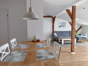 ein Esszimmer und ein Wohnzimmer mit Tisch und Stühlen in der Unterkunft Ferienwohnungen Ribnitz-Damgarten (FR) in Ribnitz-Damgarten