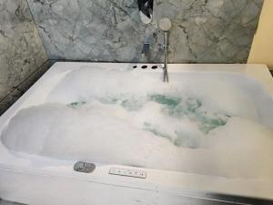 a bath tub filled with lots of snow at Hotel Magnet in Indore +34 photos