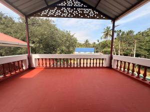 a balcony of a house with a roof at Western Castle Stay n lawn in Coimbatore +27 photos