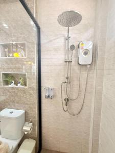 a bathroom with a shower with a toilet and a sink at PS House Bangtao in Bang Tao Beach +53 photos