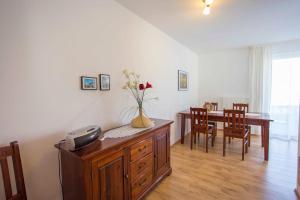 a living room with a table and a vase with flowers at Villa Boddenblick in Wiek auf Rügen +68 photos