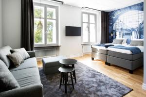 a living room with a couch and a table at Livin Station Hotel in Örebro