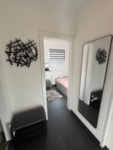 a room with a mirror and a chair and a bed at Appartement Märzenkeller in Murau