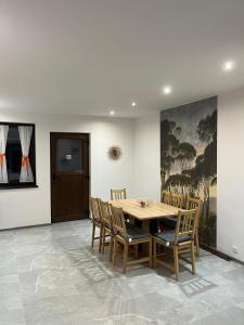 a dining room with a wooden table and chairs at Vila Soleil in Azuga +19 photos