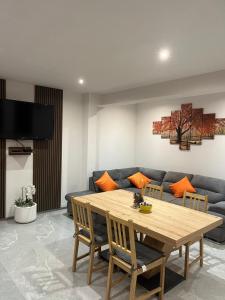 a living room with a wooden table and a blue couch at Vila Soleil in Azuga