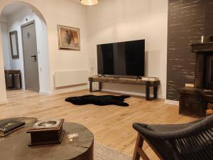 a living room with a large flat screen tv at Monastery 2 Aparthotel in Pamporovo