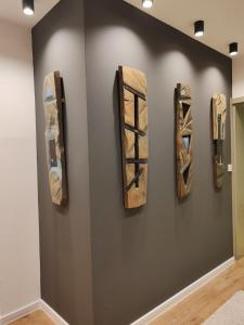 a wall with three pieces of art on a wall at Monastery 2 Aparthotel in Pamporovo