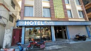 two motorcycles parked in front of a hotel at Hotel Mukti Residency in Mātigara