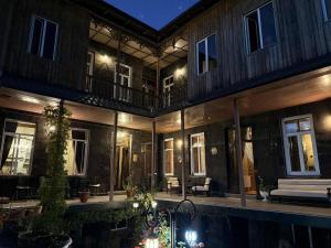 a house with a swimming pool at night at Gyumri Heritage House in Gyumri