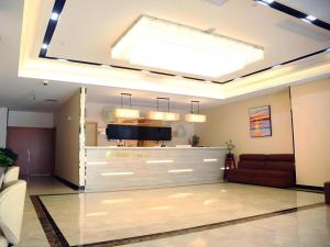 a living room with a couch and a skylight at GreenTree Inn Shanghai Fengxian District Xiaotang Metro Station in Xidu