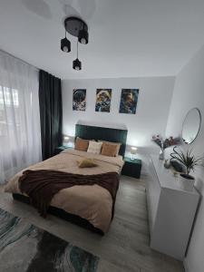 En eller flere senge i et værelse på Green Residence Rasnov