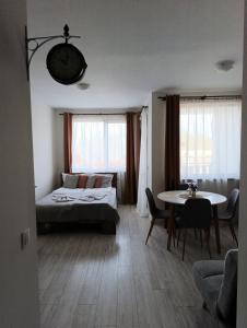 a bedroom with a bed and a table and a table and chairs at Apartment B45 Borovets Gardans in Borovets