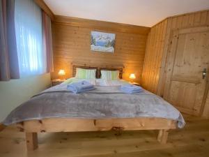 a bedroom with a large bed with two towels on it at Müllnerhof - Familie Maier in Haus im Ennstal
