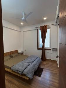 een slaapkamer met een bed en een raam bij WeHymn Homes 607 in Gomti Nagar
