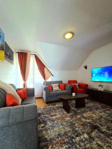 een woonkamer met een bank en een tv bij Homebound stays in Nairobi