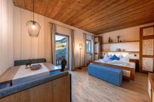 a bedroom with two beds and a large window at Camping Seiser Alm in Völs am Schlern +44 photos