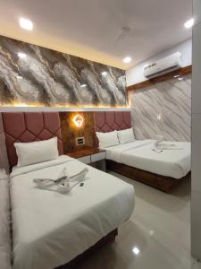 a hotel room with two beds at Hotel M R STAY in Mumbai