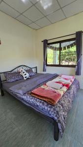 a large bed in a room with a window at Phulomnum Resort in Ban Thung Samo +204 photos
