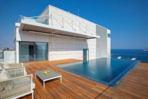 a house with a swimming pool on a deck at Olympic Residence Deluxe Apartments in Limassol