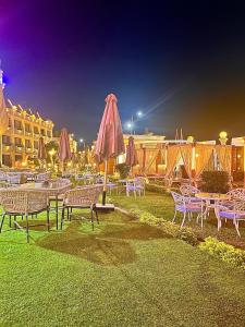 a group of tables and chairs with umbrellas at Jewel Luxor Hotel Nile View in Luxor +65 photos