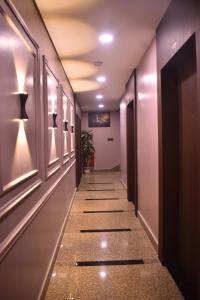 a long hallway with a long hallway sidx sidx sidx sidx at HOTEL SHIVAY Inn in Guwahati