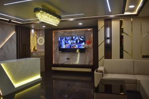 a living room with a couch and a television at HOTEL SHIVAY Inn in Guwahati