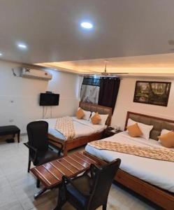 JāmbにあるHotel Royal Plaza At IGI Airportのベッド2台とテレビがあるホテルの部屋