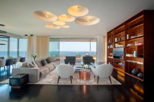 a living room with a couch and chairs at Olympic Residence Deluxe Apartments in Limassol