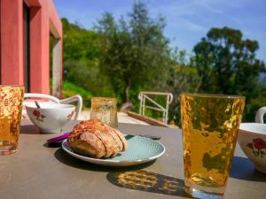 a table with a plate of food and two glasses of beer at VillaCarros - Studios in Sea & Mountain Villa near Nice with Idyllic View in Carros