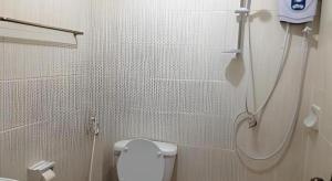 a white bathroom with a shower and a toilet at Senesouk Hotel in Vientiane +79 photos