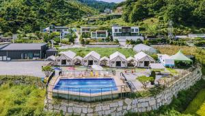 an aerial view of a resort with a swimming pool at Gapyeong Cheongchun Glamping & Caravan in Gapyeong