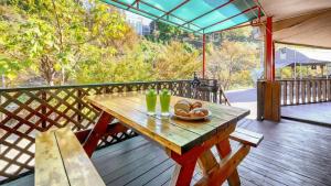 a wooden table with a bowl of bread on a deck at Gapyeong Yeoul kids pension in Gapyeong