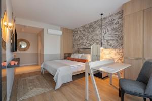 a bedroom with a bed and a desk and a chair at Oli Hotel and Suites in Antalya