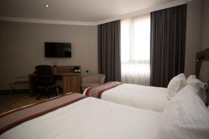 Postel nebo postele na pokoji v ubytování Batumi World Palace