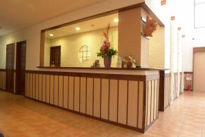 a hotel lobby with a reception counter and a mirror at Rakuchin in Naha