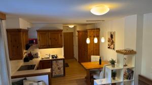 a kitchen with wooden cabinets and a wooden table at Gemütliches Apartment - Kanzelhöhe - Gerlitzen in Treffen