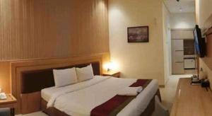 a bedroom with a large bed in a room at AZHIMA Resort and Convention in Adi Sumarmo Wiryokusumo