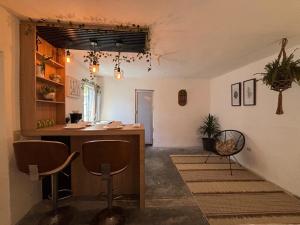 a room with a counter and chairs in a room at Apartment #3 for 4 WiFi-centric-consulate in Matamoros